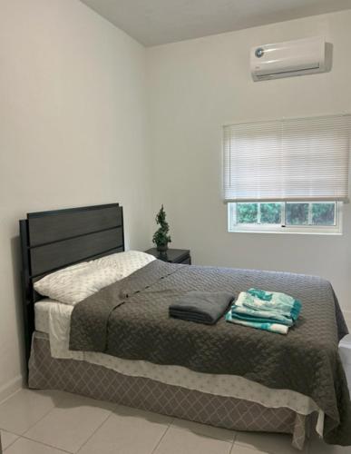 a bedroom with a bed and a window at Hagat Sunset Retreat in Agat