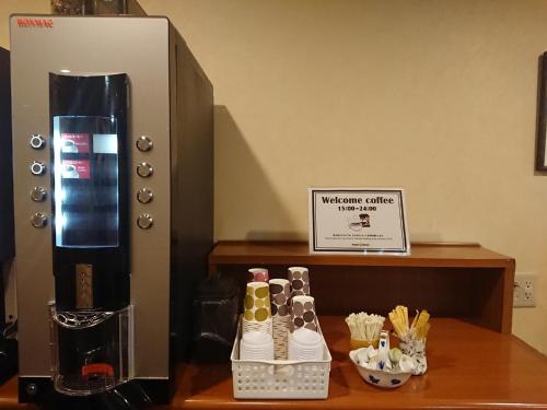 a group of shoes on a table next to a coffee maker at Smile Hotel Kobe Motomachi - Vacation STAY 85865v in Kobe