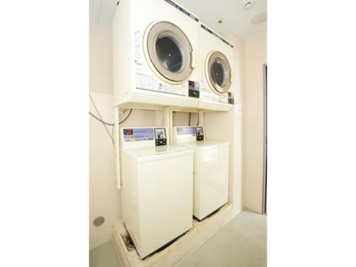 a laundry room with two microwaves on a shelf at Smile Hotel Kobe Motomachi - Vacation STAY 85865v in Kobe