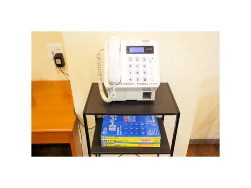 a phone sitting on a table in a room at Smile Hotel Kobe Motomachi - Vacation STAY 85865v in Kobe