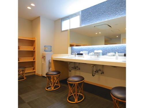 a bathroom with two bar stools and a sink at Smile Hotel Anan - Vacation STAY 88768v in Anan