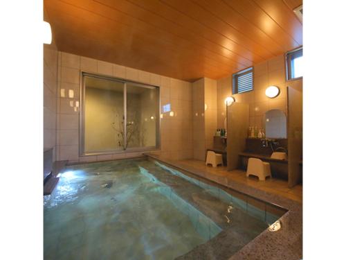 a bathroom with a swimming pool with a sink at Smile Hotel Anan - Vacation STAY 88776v in Anan