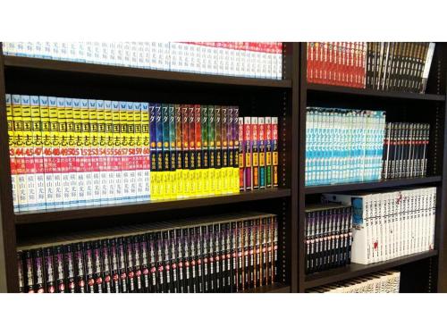 a shelf filled with lots of different colored dvds at Smile Hotel Anan - Vacation STAY 88749v in Anan