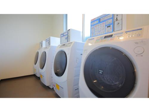 a row of washing machines in a laundry room at Smile Hotel Anan - Vacation STAY 88749v in Anan