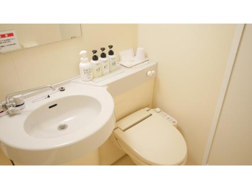 a bathroom with a white toilet and a sink at Smile Hotel Shizuoka Yoshida Inter - Vacation STAY 90908v 