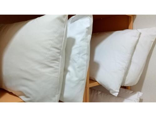 two white pillows sitting on top of a bed at Smile Hotel Shizuoka Yoshida Inter - Vacation STAY 90911v 