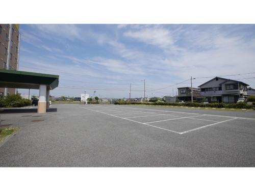 an empty parking lot next to a building at Smile Hotel Shizuoka Yoshida Inter - Vacation STAY 90880v 