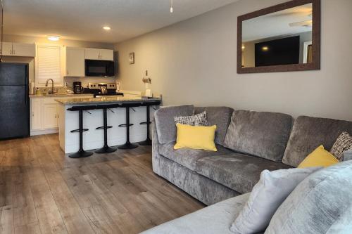 a living room with a couch and a kitchen at Misty Harbor Beach Retreat in Gilford