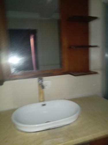 a white sink on a counter with a mirror at إثيوبيا أديس in Addis Ababa