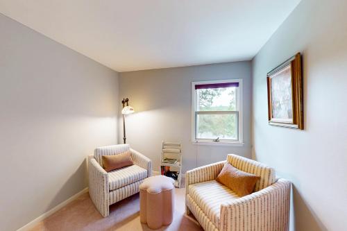 a living room with two chairs and a window at Turtle Bay in Minocqua