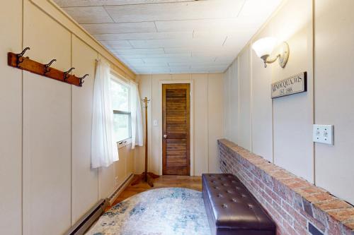 a living room with a bench and a door at Turtle Bay in Minocqua