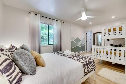 a bedroom with a large bed and a window at Sweetfern Gouldsboro Cabin Deck and Lake Access in Gouldsboro