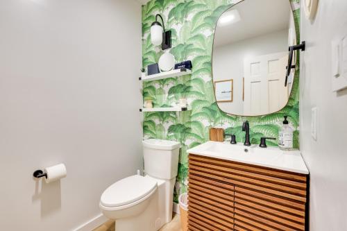 a bathroom with a toilet and a mirror at Sweetfern Gouldsboro Cabin Deck and Lake Access in Gouldsboro