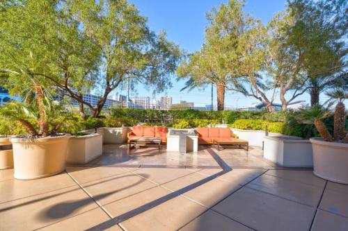 an outdoor patio with chairs and plants and trees at Mgm 1 Bedroom Balcony And Or Studio Luxury Suites in Las Vegas