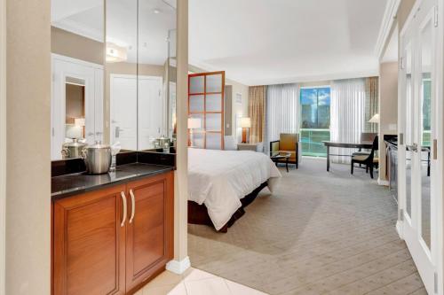 a bedroom with a bed and a sink and a desk at Mgm 1 Bedroom Balcony And Or Studio Luxury Suites in Las Vegas