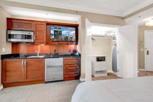 a kitchen with wooden cabinets and a sink at Mgm 1 Bedroom Balcony And Or Studio Luxury Suites in Las Vegas