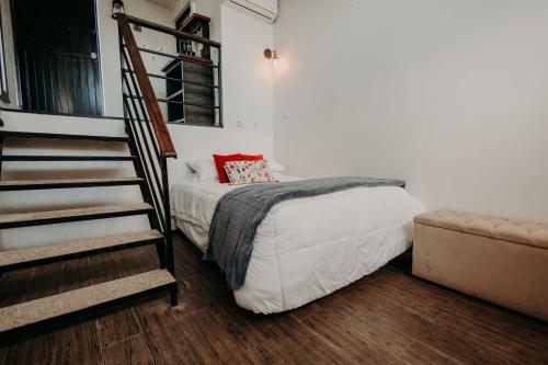 a bedroom with a bed and a stair case at DaNik Valle in Francisco Zarco