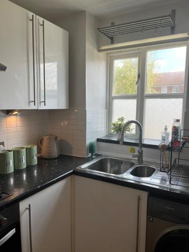 a kitchen with a sink and a window at 1 bed Flat Greater London in New Malden