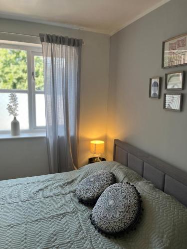 a bedroom with a bed with pillows and a window at 1 bed Flat Greater London in New Malden