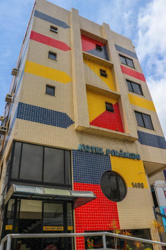 a building with colorful windows on the side of it at Hotel Piramide Pituba - Av Paulo VI in Salvador