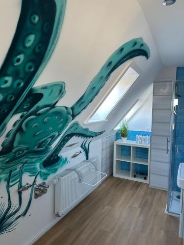 a bathroom with a whale mural on the wall at Lütt Lubotne in Laboe