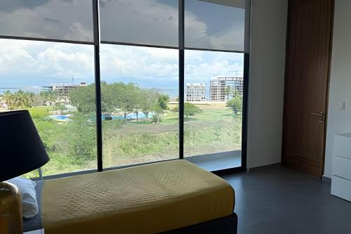 a room with a bed and a large window at Alojamiento familiar en B Nayar in Cruz de Huanacaxtle
