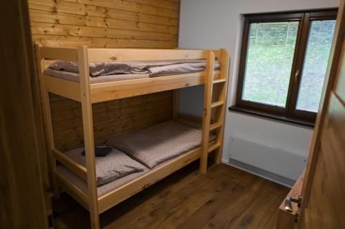 a couple of bunk beds in a room with a window at Horská Chata Čeladná in Čeladná