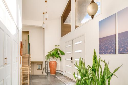 a hallway with a door and a plant at Mid-Century Escape 7 BR Sleeps 22 Hot Tub & Games in Westminster