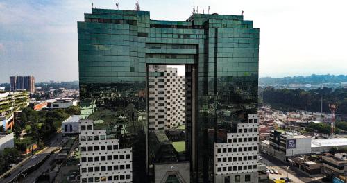 a tall glass building in the middle of a city at Tikal Futura Hotel & Convention Center in Guatemala