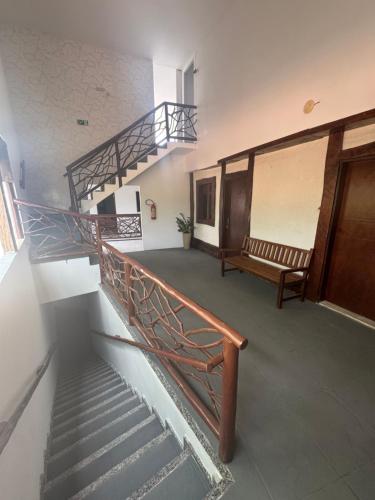 a staircase in a building with a bench and a stair case at Hotel beleléus Jericoacoara in Jericoacoara