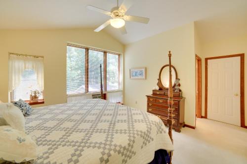 a bedroom with a bed and a ceiling fan at Private Beach! Year-Round Lake Superior Retreat in Marquette