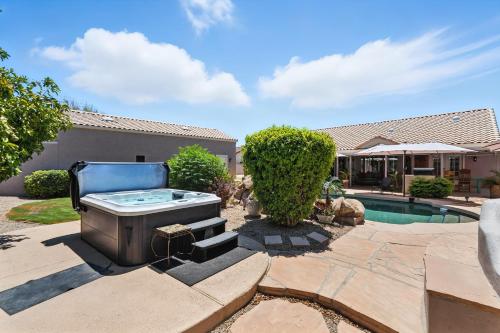a hot tub in a yard next to a pool at Private Tuscany Oasis with Pool - Perfect for families, couples or business travelers home in Phoenix