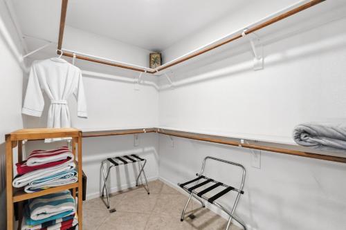a room with a closet with a shelf and chairs at Private Tuscany Oasis with Pool - Perfect for families, couples or business travelers home in Phoenix