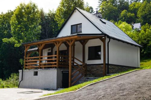 a home with a gambrel roof and a garage at Horská Chata Čeladná in Čeladná