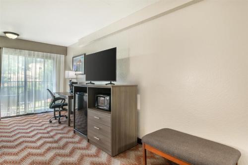 a hotel room with a desk and a television at Best Western Plus Sonora Oaks Hotel and Conference Center in Sonora
