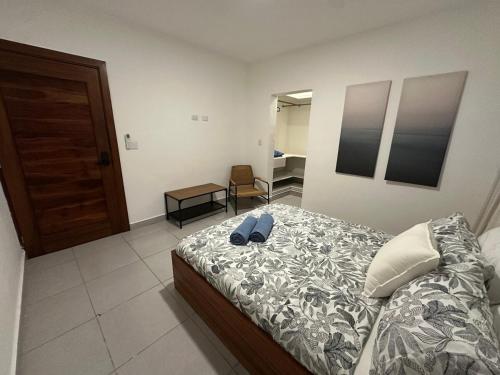 a bedroom with a bed with a pair of shoes on it at Apartamento en La Romana buena vista norte Jacuzzi in La Romana