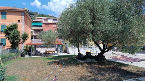 a tree and a swing set in a yard at LE GEMME Bed & Breakfast con parcheggio e giardino in Casarza Ligure