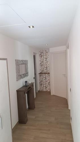 a room with a hallway with a sink and a mirror at LE GEMME Bed & Breakfast con parcheggio e giardino in Casarza Ligure