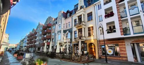 a row of buildings on a city street at 1904 Studio in Świnoujście
