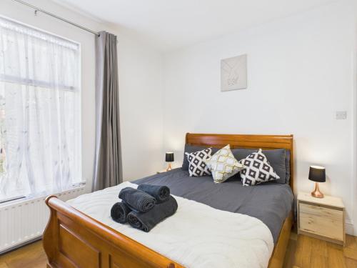 a bedroom with a bed with towels on it at Stylish 4BR North London Home by D3 Short Stay, Sleeps 9, Piccadilly Line in London