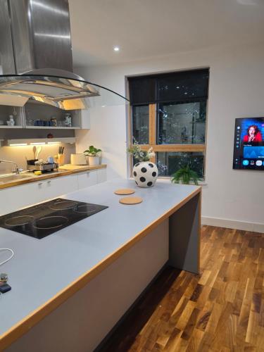 a kitchen with a soccer ball on a counter at Hacienda - in Manchester