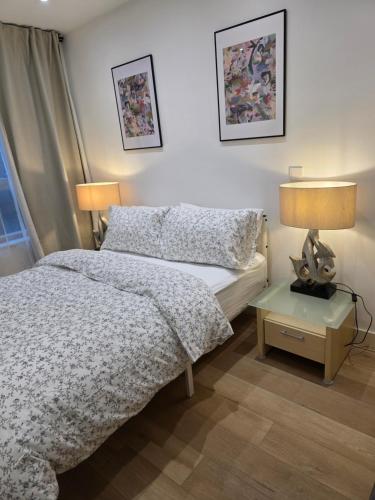 a bedroom with a bed and a table with a lamp at Hacienda - in Manchester