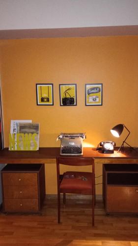 a desk with a keyboard and a phone on it at InspireBA - Terrace in Buenos Aires