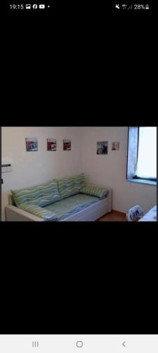 a bed in a bedroom with pictures on the wall at B&B Il Tiglio in Lapio