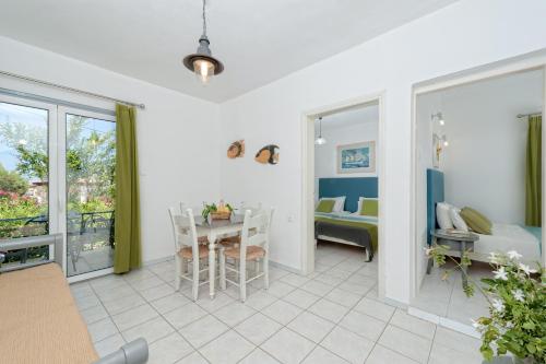 a living room with a table and a bedroom at Creta Vitalis in Kalathas
