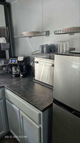 a kitchen with a counter top and a refrigerator at Cozy Foldable Container Pipestem Getaway For 2 in Pipestem