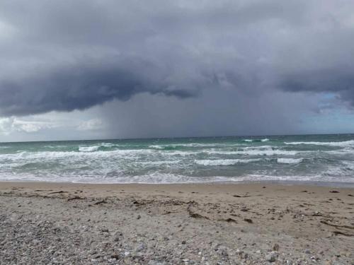 a beach with a cloudy sky and the ocean at 4 person holiday home in Græsted-By Traum in Græsted