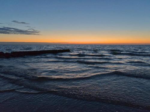 a view of the ocean at sunset at 4 person holiday home in Græsted-By Traum in Græsted