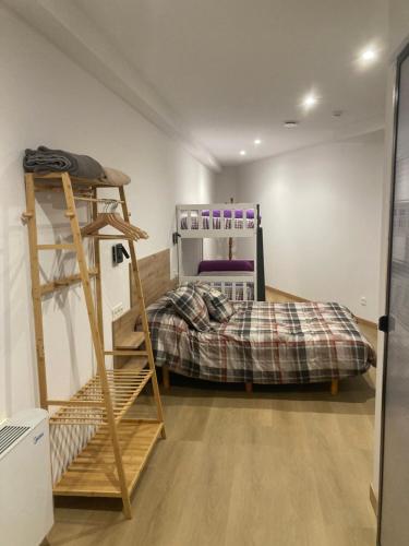 a room with a bunk bed and a ladder at Studio&Rooms Ortuzar in Durango