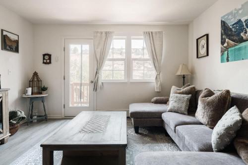 a living room with a couch and a coffee table at Explore Relax Repeat - Riverside Views - Eagle in Eagle